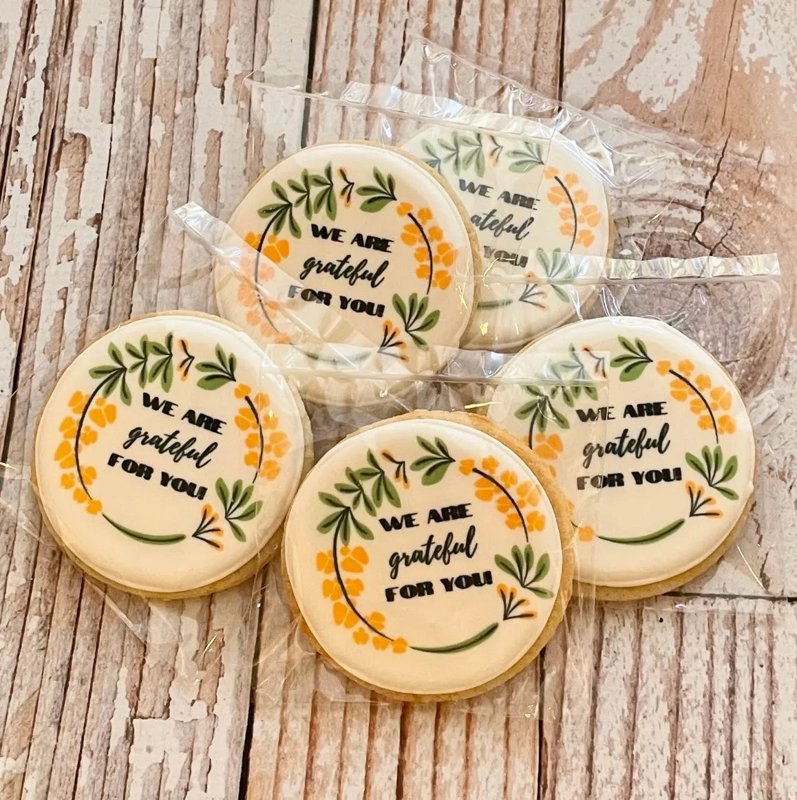 Sugar cookies with We Are Grateful For You message in hand-painted floral wreath