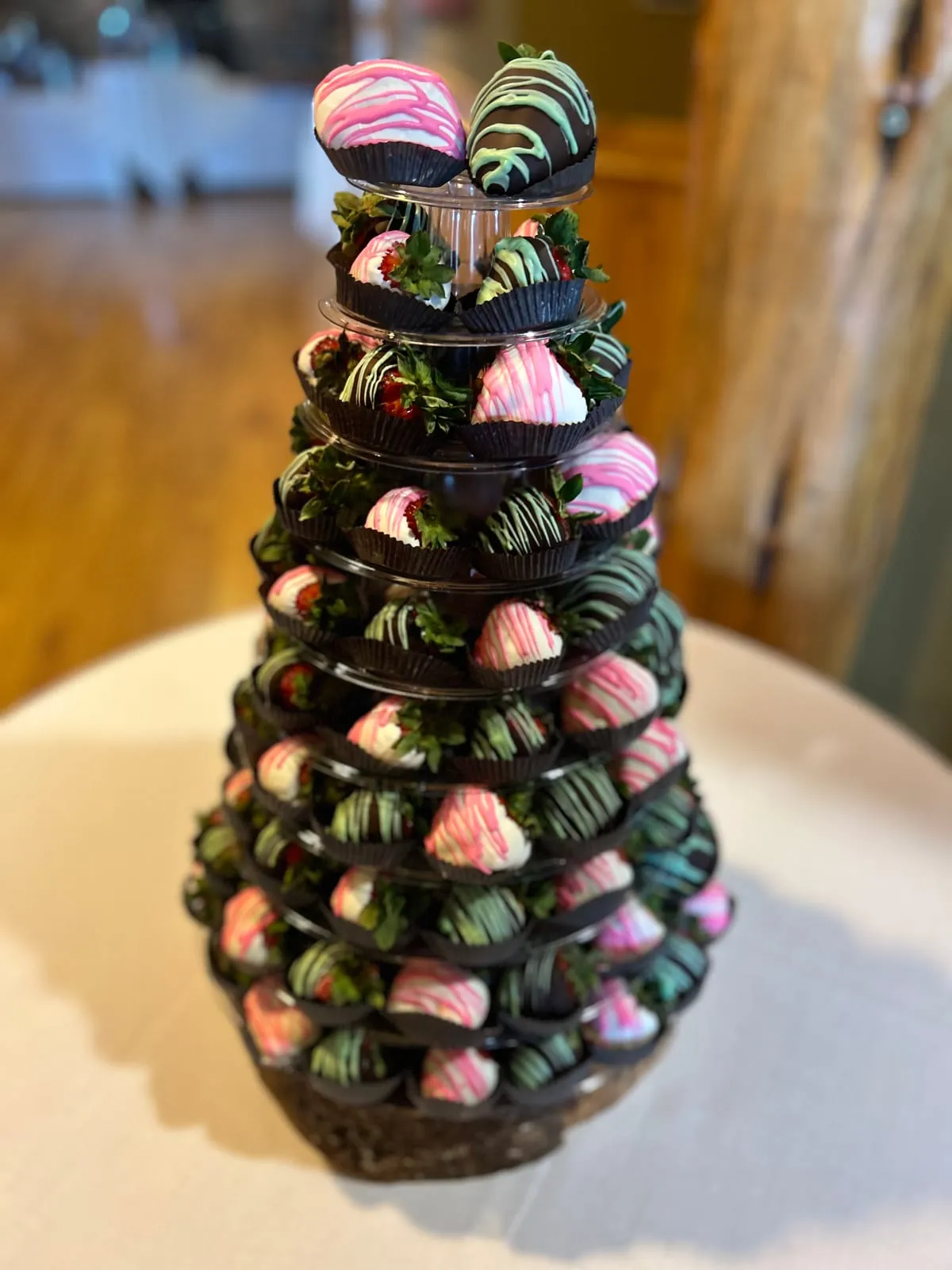 A tall artisan Event Tower of truffles, gourmet strawberries, and macarons